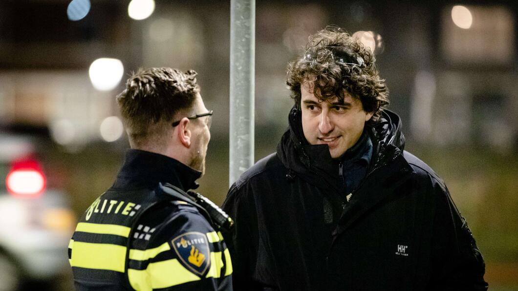 Jesse Klaver praat met een politieagent op straat tijdens oud en nieuw.